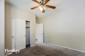 Surprise house for rent - a bedroom with a ceiling fan and a closet