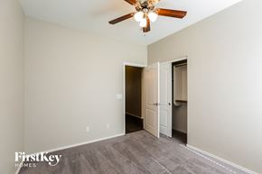 Surprise house for rent - a living room with a ceiling fan and a door to a closet