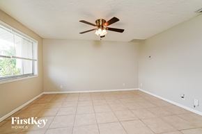 Cape Coral house for rent - A room with a ceiling fan and tile flooring.