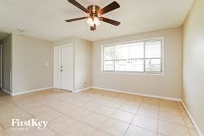 Cape Coral house for rent - A room with a ceiling fan and a window.