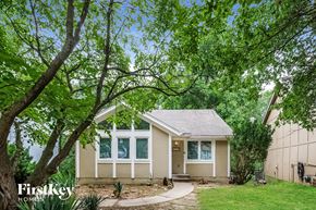 Kansas City house for rent - A small house with a tree in front of it.