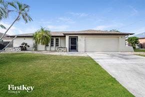 Cape Coral house for rent - A house with a garage and a driveway in front of it.