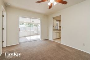 Cape Coral house for rent - A spacious room with a carpeted floor and a ceiling fan.