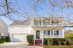 Charlotte house for rent - a white house with a porch and a tree in front of it