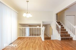 Homer Glen house for rent - A large open living space with a staircase leading to the upper floor.
