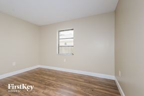 Port St. Lucie house for rent - a bedroom with hardwood flooring and a window