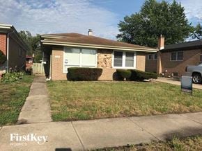 Dolton house for rent - a brick house with a sidewalk in front of it
