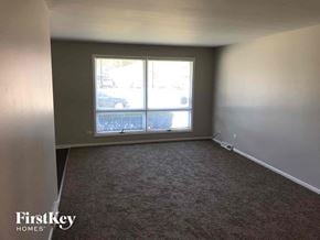 Dolton house for rent - an empty living room with a large window