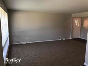 Dolton house for rent - an empty living room with a white wall and carpet