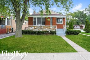 Dolton house for rent - the front of a brick house with stairs and a lawn