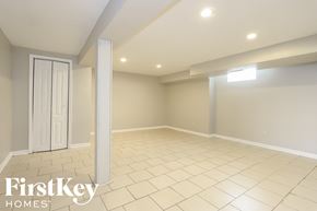 Dolton house for rent - the spacious living room has a large tiled floor and a white door