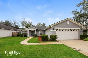St. Augustine house for rent - A house with a garage door and a driveway in front of it.