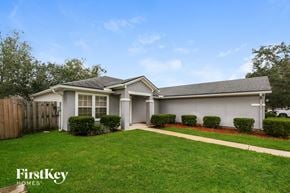 St. Augustine house for rent - A house with a well-maintained lawn and a clear sky.