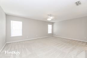 St. Augustine house for rent - A spacious empty room with a FirstKey Homes logo.