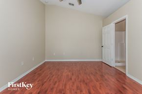 Port St. Lucie house for rent - a living room with wood flooring and a white door