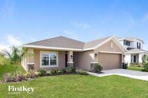 Wimauma house for rent - a beige house with a lawn and a driveway