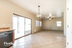 Surprise house for rent - A spacious room with a tile floor and a ceiling fan.