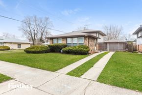 Dolton house for rent - a home with a sidewalk and lawn in front of it