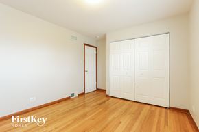 Dolton house for rent - a bedroom with two closets and a wood floor