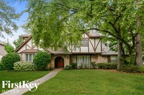 Houston house for rent - A house with a red door and a tree in front of it.