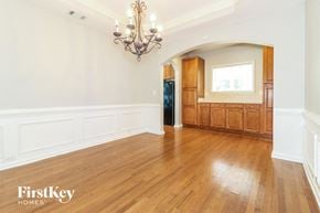 Cumming house for rent - A well-lit room with wooden floors and a chandelier.