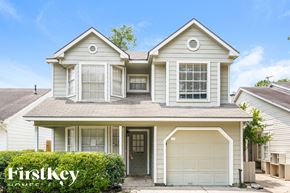 Houston house for rent - a white house with white shutters and a garage door