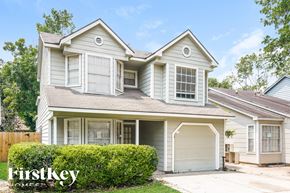 Houston house for rent - a white house with white shutters and a garage