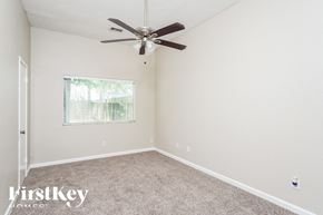 Houston house for rent - a bedroom with carpet and a ceiling fan