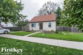 Midlothian house for rent - a small white house with a yard and a sidewalk