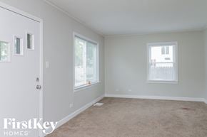 Midlothian house for rent - a room with a carpet and a door and two windows