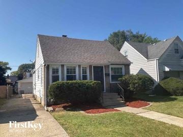 Dolton house for rent - a small white house with a porch and a sidewalk