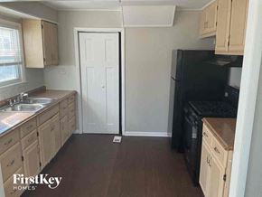 Dolton house for rent - a small kitchen with a sink and a refrigerator