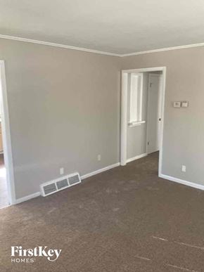 Dolton house for rent - an empty room with a hallway and a door to a closet