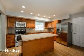 Florissant house for rent - an updated kitchen with stainless steel appliances and wooden cabinets