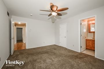 Florissant house for rent - a living room with carpet and a ceiling fan