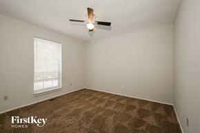 Florissant house for rent - a bedroom with carpet and a ceiling fan