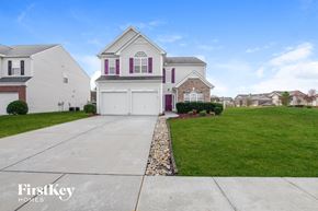 Charlotte house for rent - A house with a white garage door and a stone border.