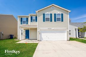 Noblesville house for rent - a beige house with a white garage door