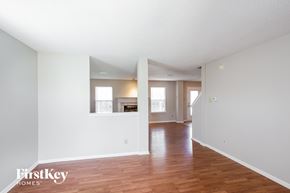 Noblesville house for rent - the living room and dining room with hardwood floors and white walls