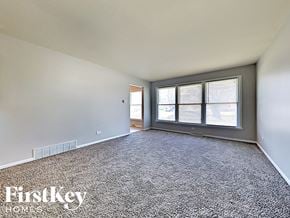 Dolton house for rent - the living room of an empty house with a large window