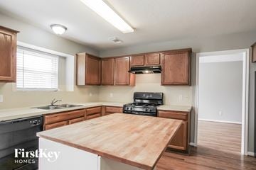 Houston house for rent - A kitchen with wooden cabinets and a wooden countertop.