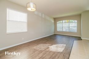 Orlando house for rent - an empty living room with wood flooring and a large window