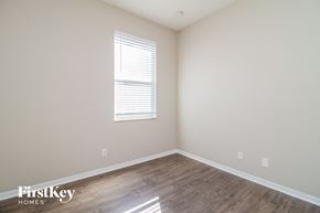 Orlando house for rent - the upstairs bedroom with wood flooring and a window