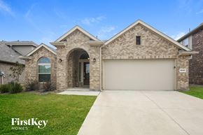 Haslet house for rent - a brick house with a garage and a driveway
