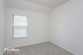 Haslet house for rent - a bedroom with white walls and a window and a carpet