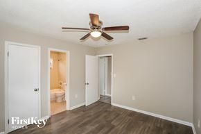 Homestead house for rent - a living room with a ceiling fan and a door to a bathroom