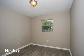 Homestead house for rent - a bedroom with wood floors and a window