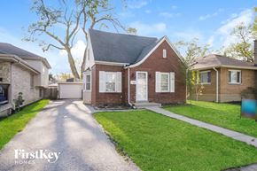 Midlothian house for rent - a small brick house with a driveway and lawn