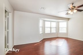 Surprise house for rent - a living room with wood floors and a ceiling fan