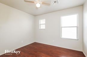 Surprise house for rent - a bedroom with wood flooring and a ceiling fan